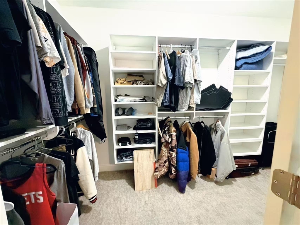 16 Taylor Drive, Unit 1010 Reading, MA 01867 - Photo 18 of 24 a view of walk in closet with clothes and shoes