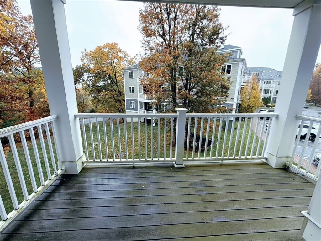 16 Taylor Drive, Unit 1010 Reading, MA 01867 - Photo 20 of 24 a view of a balcony with wooden floor