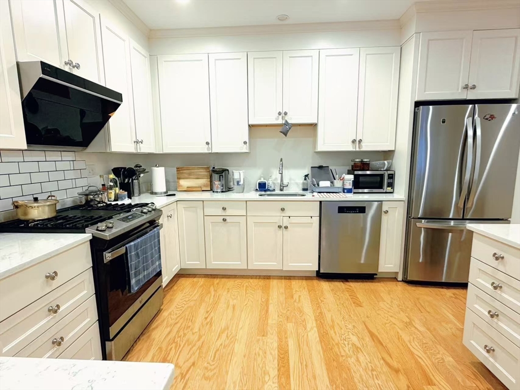 16 Taylor Drive, Unit 1010 Reading, MA 01867 - Photo 3 of 24 a kitchen with stainless steel appliances granite countertop a stove a sink dishwasher and a refrigerator