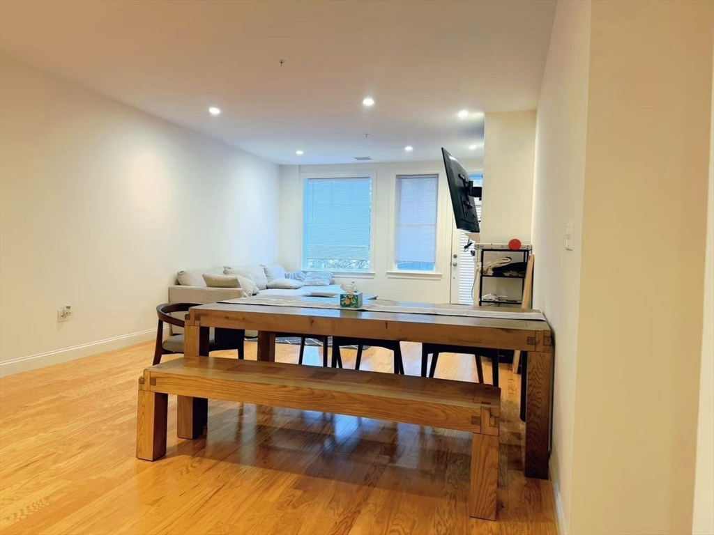 16 Taylor Drive, Unit 1010 Reading, MA 01867 - Photo 5 of 24 a view of a dining room with furniture and wooden floor