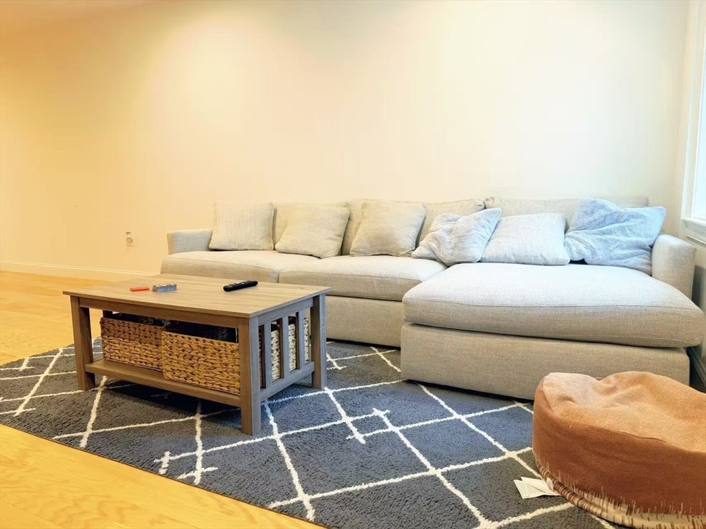 16 Taylor Drive, Unit 1010 Reading, MA 01867 - Photo 6 of 24 a terrace with a couch and a table