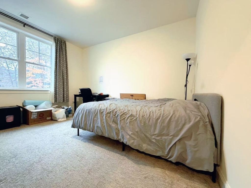 16 Taylor Drive, Unit 1010 Reading, MA 01867 - Photo 7 of 24 a bedroom with a bed and a couch