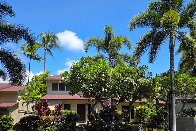 a view of a house with a palm trees