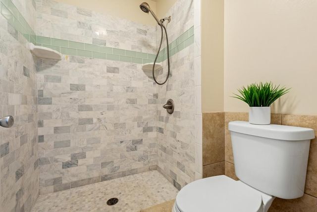 a bathroom with a toilet and a shower