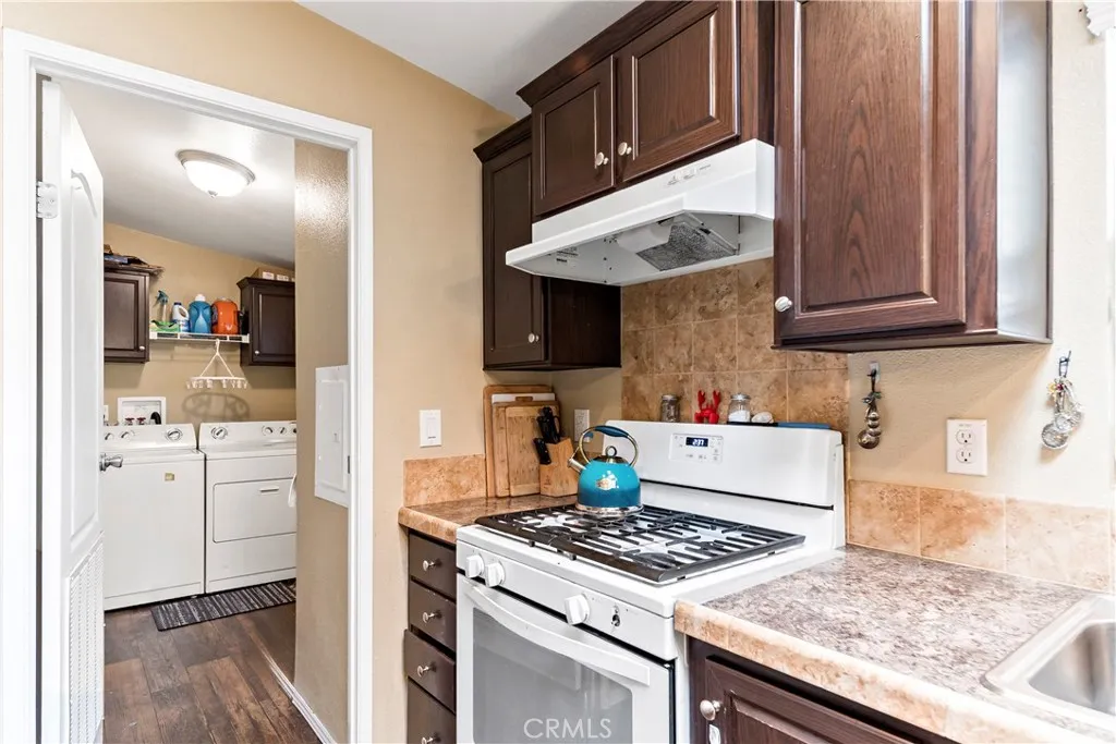 2755 Arrow La, Unit 106 La Verne, CA 91750 - Photo 12 of 28 a kitchen with stainless steel appliances granite countertop a stove and a refrigerator