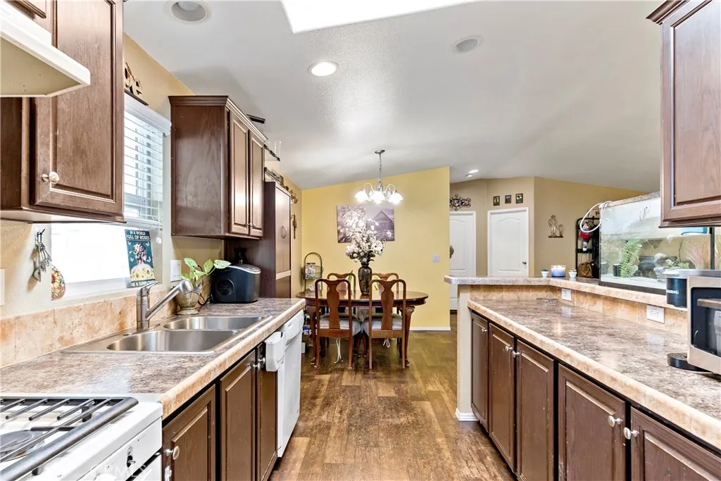2755 Arrow La, Unit 106 La Verne, CA 91750 - Photo 13 of 28 a kitchen with granite countertop a sink stove and cabinets