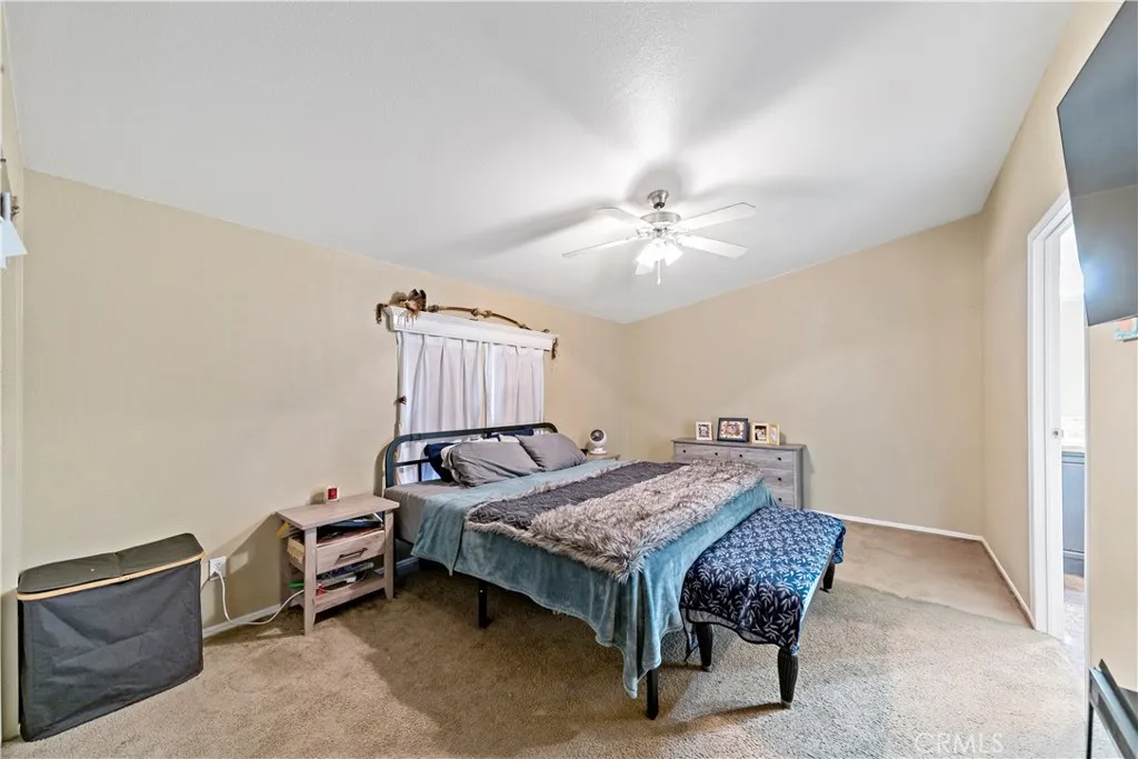 2755 Arrow La, Unit 106 La Verne, CA 91750 - Photo 14 of 28 a bedroom with a bed and a chandelier