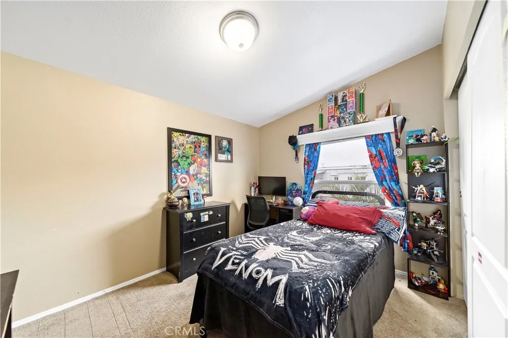 2755 Arrow La, Unit 106 La Verne, CA 91750 - Photo 17 of 28 a bedroom with a bed and a book shelf