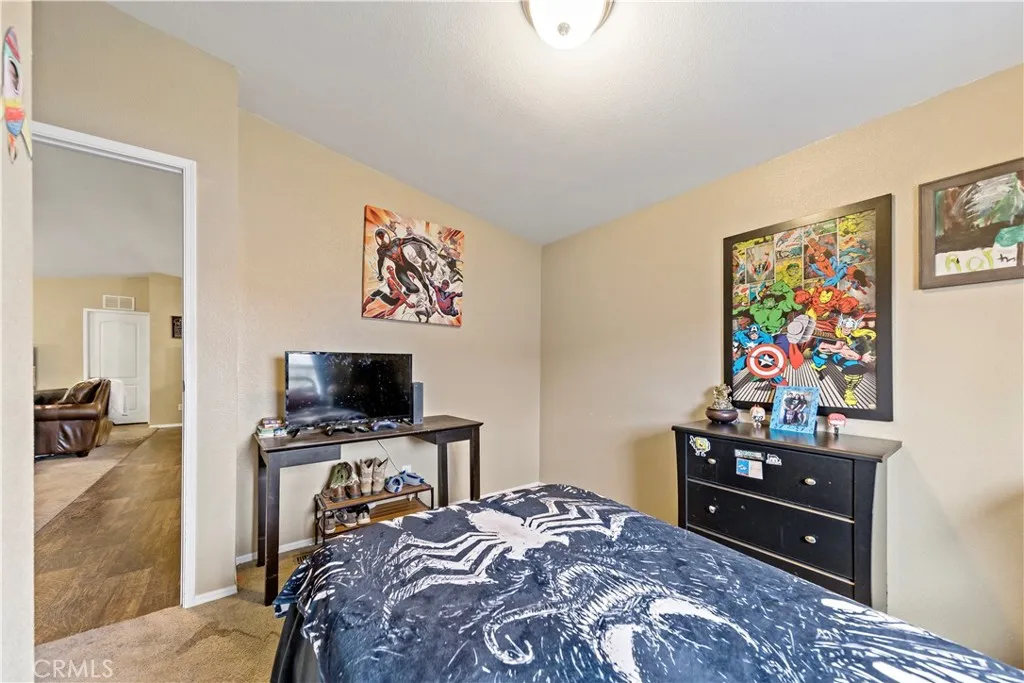 2755 Arrow La, Unit 106 La Verne, CA 91750 - Photo 18 of 28 a bedroom with a bed and a television