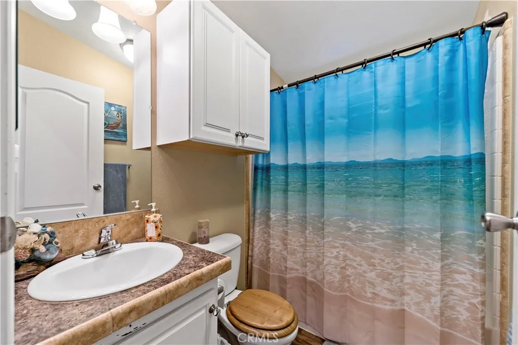 2755 Arrow La, Unit 106 La Verne, CA 91750 - Photo 20 of 28 a bathroom with a granite countertop sink and a mirror