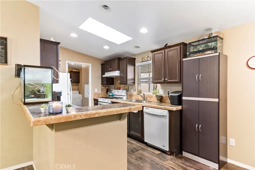 2755 Arrow La, Unit 106 La Verne, CA 91750 - Photo 9 of 28 a kitchen with stainless steel appliances a sink stove refrigerator and cabinets