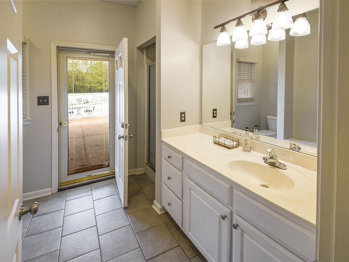 890 South Collierville Arlington Road Collierville, TN 38017 - Photo 15 of 24 Perfect location with access to pool. There is a stand up shower next to cabinets. Cabinets in laundry, kitchen, and two of 3 bathroom down are white. Most of the downstairs walls, doors, & jams have been freshly painted July 2019.