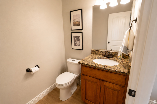 896 Cres Drive South Mapleton, UT 84664 - Photo 11 of 32 Bathroom vanity featuring a granite countertop with an undermount sink and a wood-finish cabinet