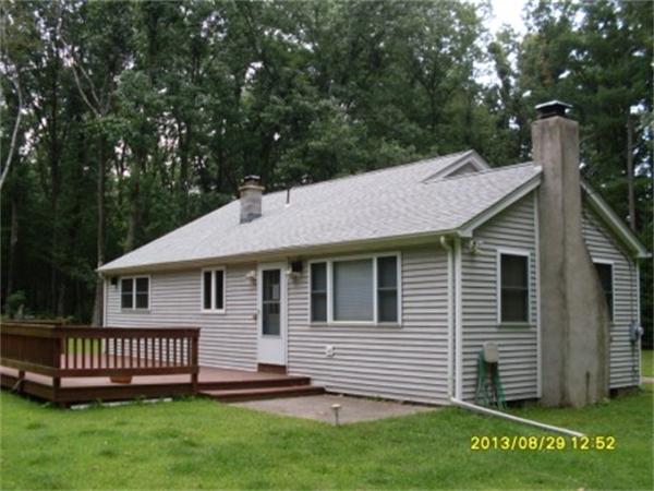 a view of a house with a yard and deck