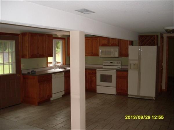 730 N Road Westfield, MA 01085 - Photo 6 of 10 a kitchen with granite countertop a refrigerator and a stove top oven