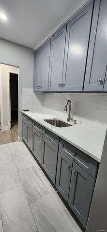 a kitchen with a sink and cabinets
