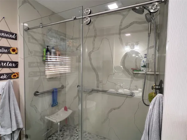 a bathroom with a shower and a sink