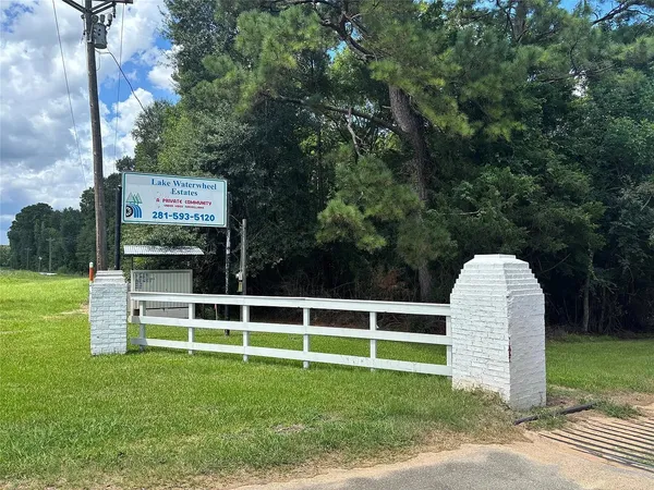 a view of a wooden fence and a big yard