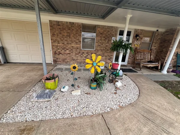 a view of a porch with a table and chairs