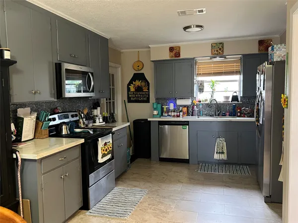 a kitchen with a sink stove and microwave