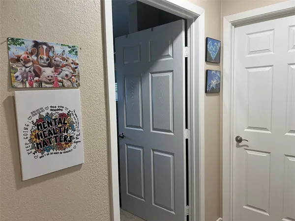 a view of a hallway with a painting on the wall