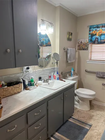 a spacious bathroom with a sink and a mirror