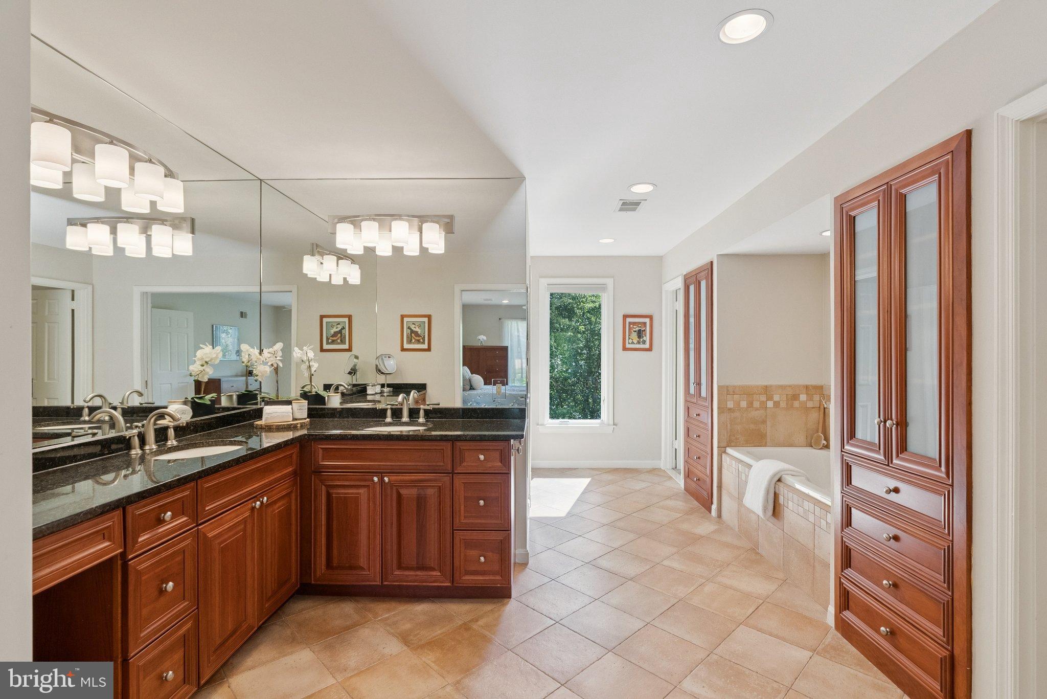 9817 Conestoga Way Potomac, MD 20854 - Photo 19 of 35 a large bathroom with a large tub and sink