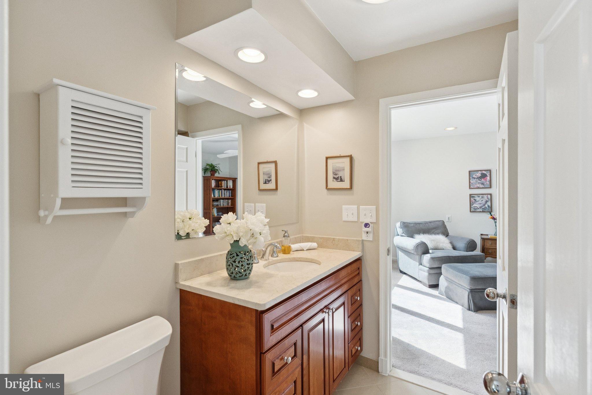 9817 Conestoga Way Potomac, MD 20854 - Photo 23 of 35 a bathroom with a sink vanity and a mirror