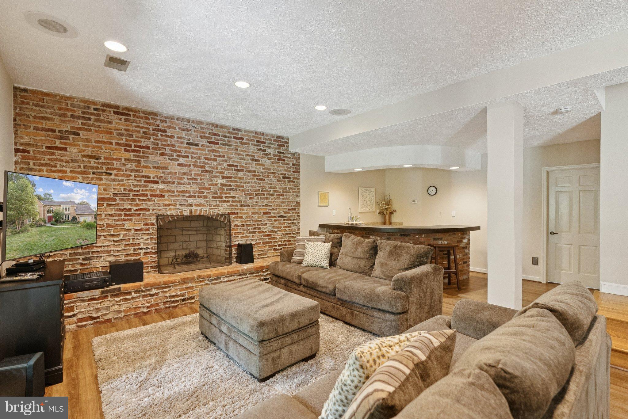 9817 Conestoga Way Potomac, MD 20854 - Photo 28 of 35 a living room with furniture and a fireplace
