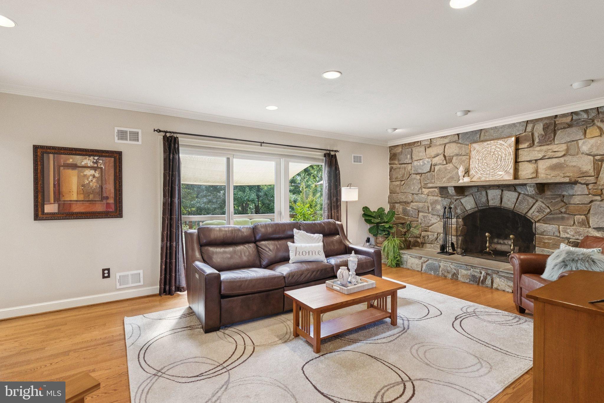 9817 Conestoga Way Potomac, MD 20854 - Photo 6 of 35 a living room with furniture and a fireplace