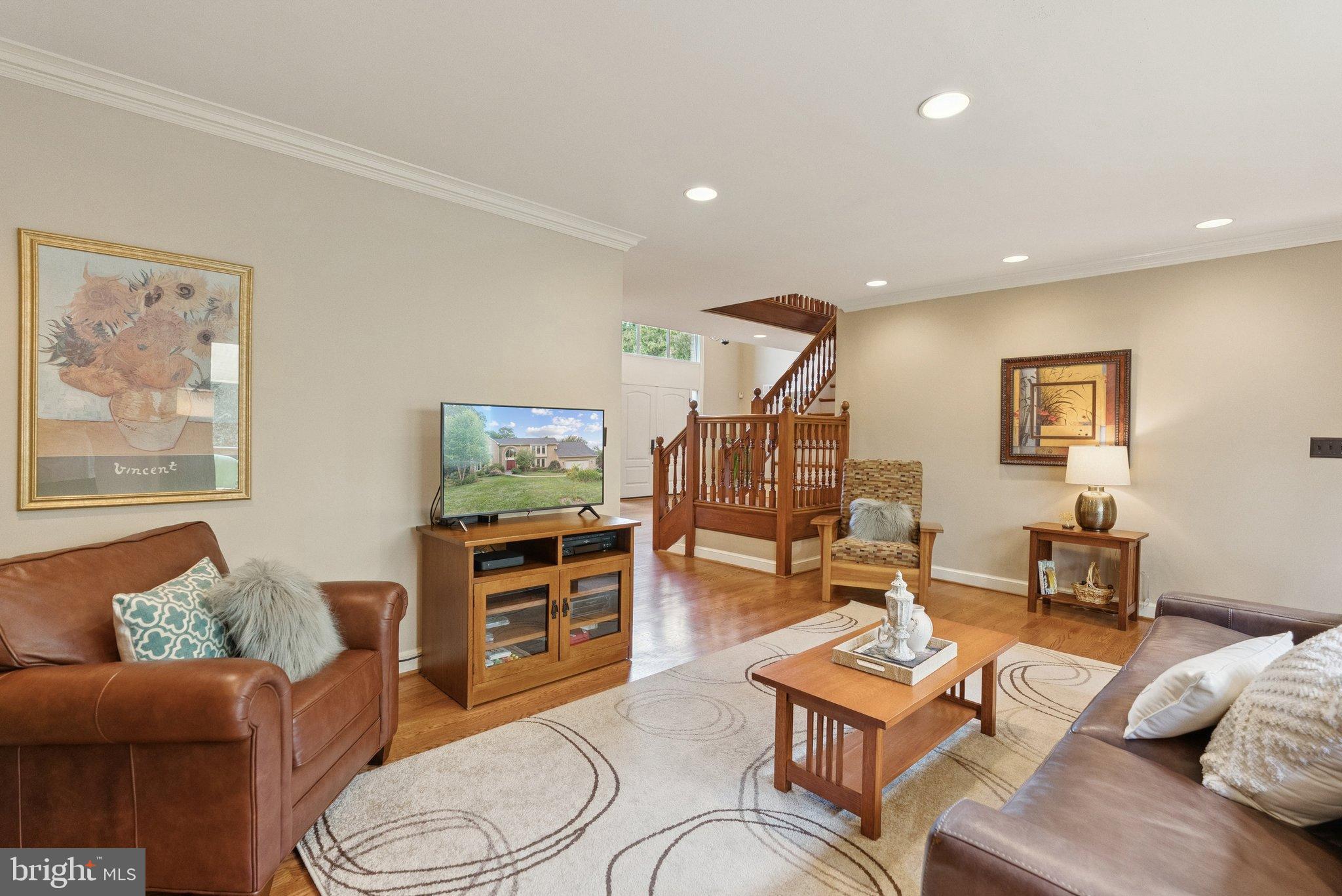 9817 Conestoga Way Potomac, MD 20854 - Photo 7 of 35 a living room with furniture and a flat screen tv