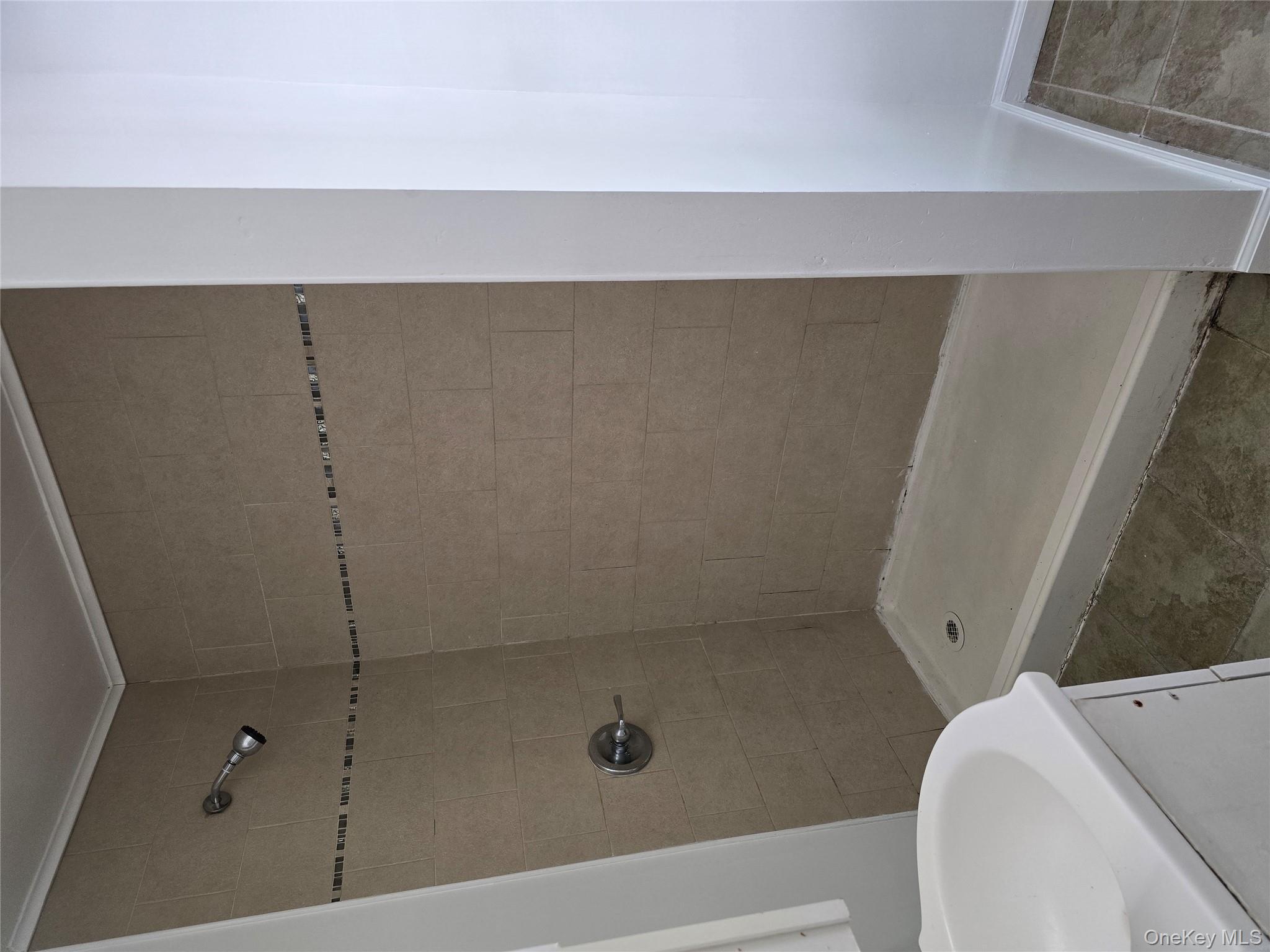 19 Elizabeth Street, Unit 1 Port Jervis, NY 12771 - Photo 13 of 16 a bathroom with a tub and a shower