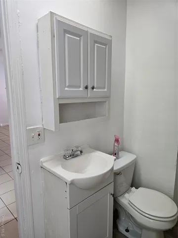 a bathroom with a sink toilet and a mirror