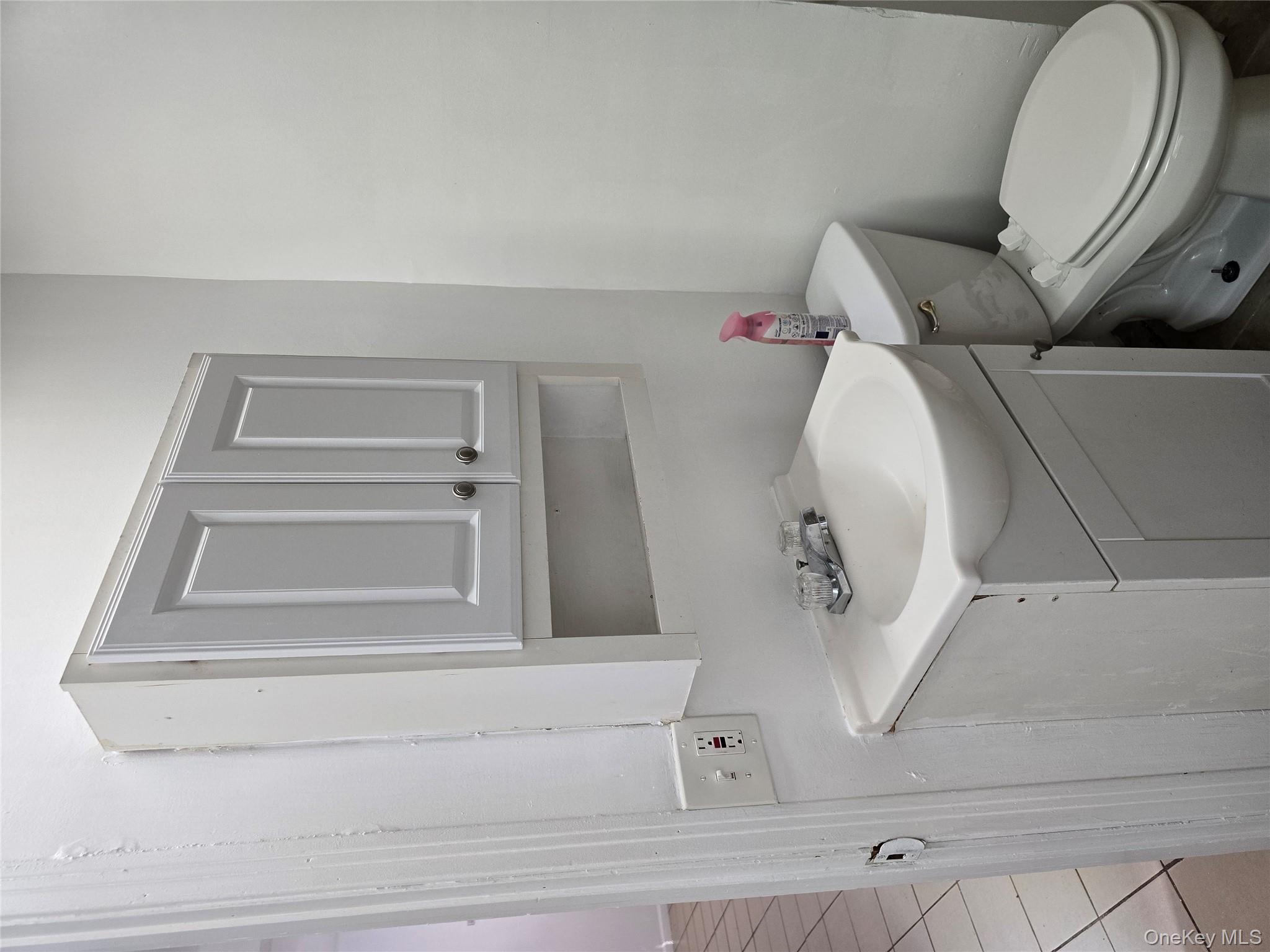 19 Elizabeth Street, Unit 1 Port Jervis, NY 12771 - Photo 14 of 16 a bathroom with a sink mirror vanity and toilet