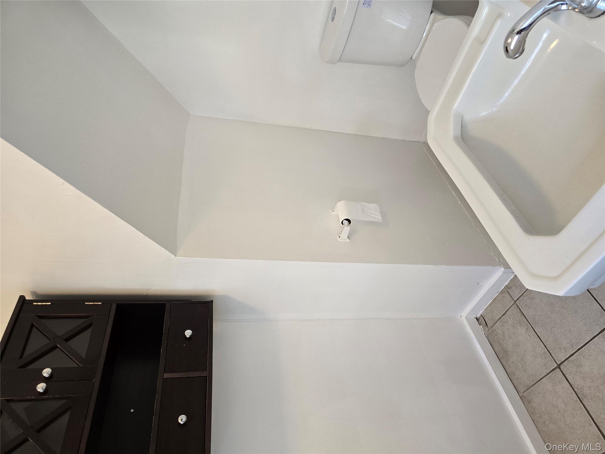 19 Elizabeth Street, Unit 1 Port Jervis, NY 12771 - Photo 16 of 16 a bathroom with a sink and toilet