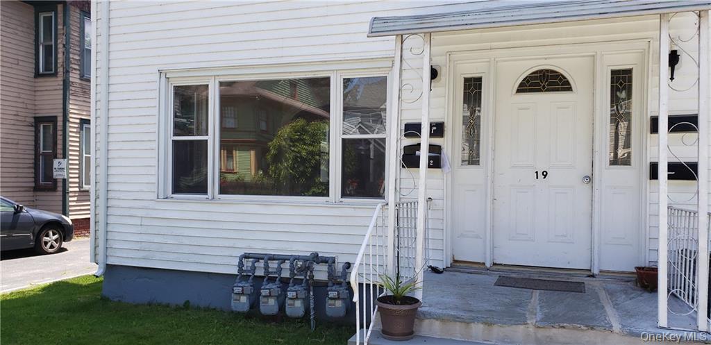19 Elizabeth Street, Unit 1 Port Jervis, NY 12771 - Photo 2 of 16 a view of a porch with chairs and potted plants next to a yard