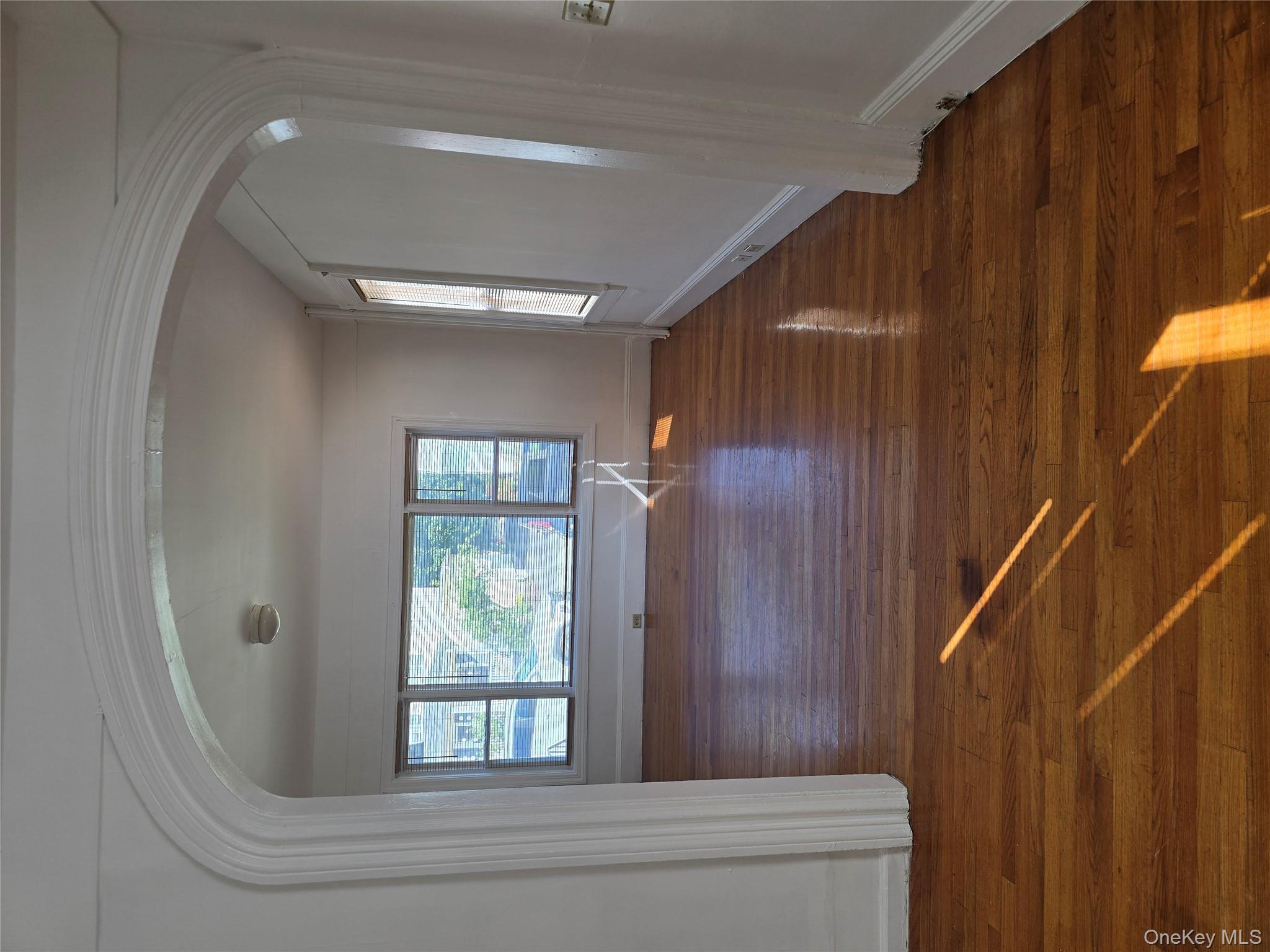 19 Elizabeth Street, Unit 1 Port Jervis, NY 12771 - Photo 3 of 16 a view of empty room with wooden floor and fan