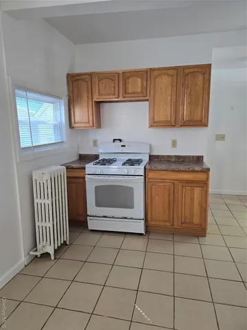 a kitchen with stainless steel appliances a stove sink and cabinets