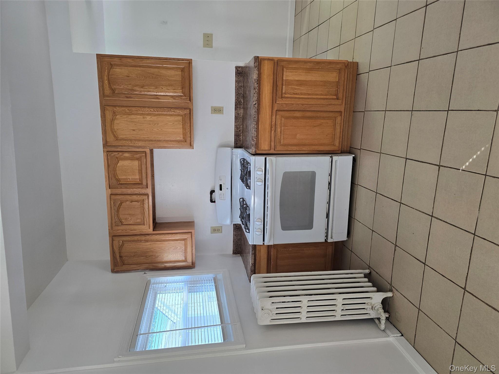 19 Elizabeth Street, Unit 1 Port Jervis, NY 12771 - Photo 5 of 16 a kitchen with stainless steel appliances a stove sink and cabinets