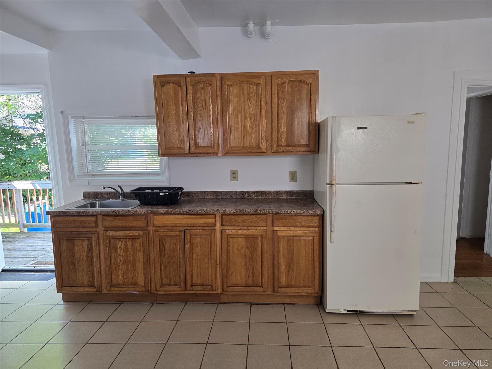 19 Elizabeth Street, Unit 1 Port Jervis, NY 12771 - Photo 6 of 16 a kitchen with stainless steel appliances granite countertop a refrigerator sink and cabinets