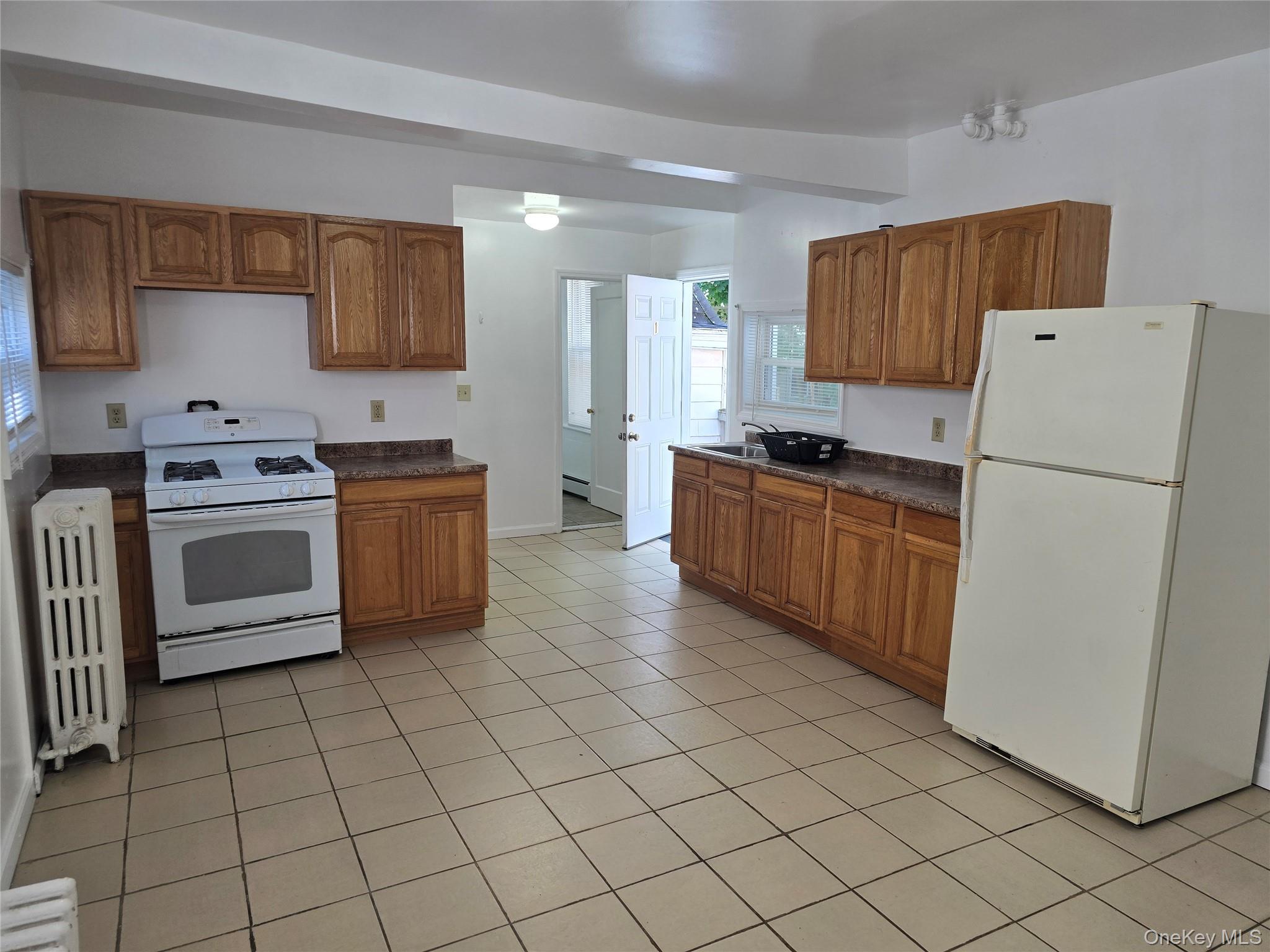 19 Elizabeth Street, Unit 1 Port Jervis, NY 12771 - Photo 7 of 16 a kitchen with stainless steel appliances a refrigerator sink and cabinets