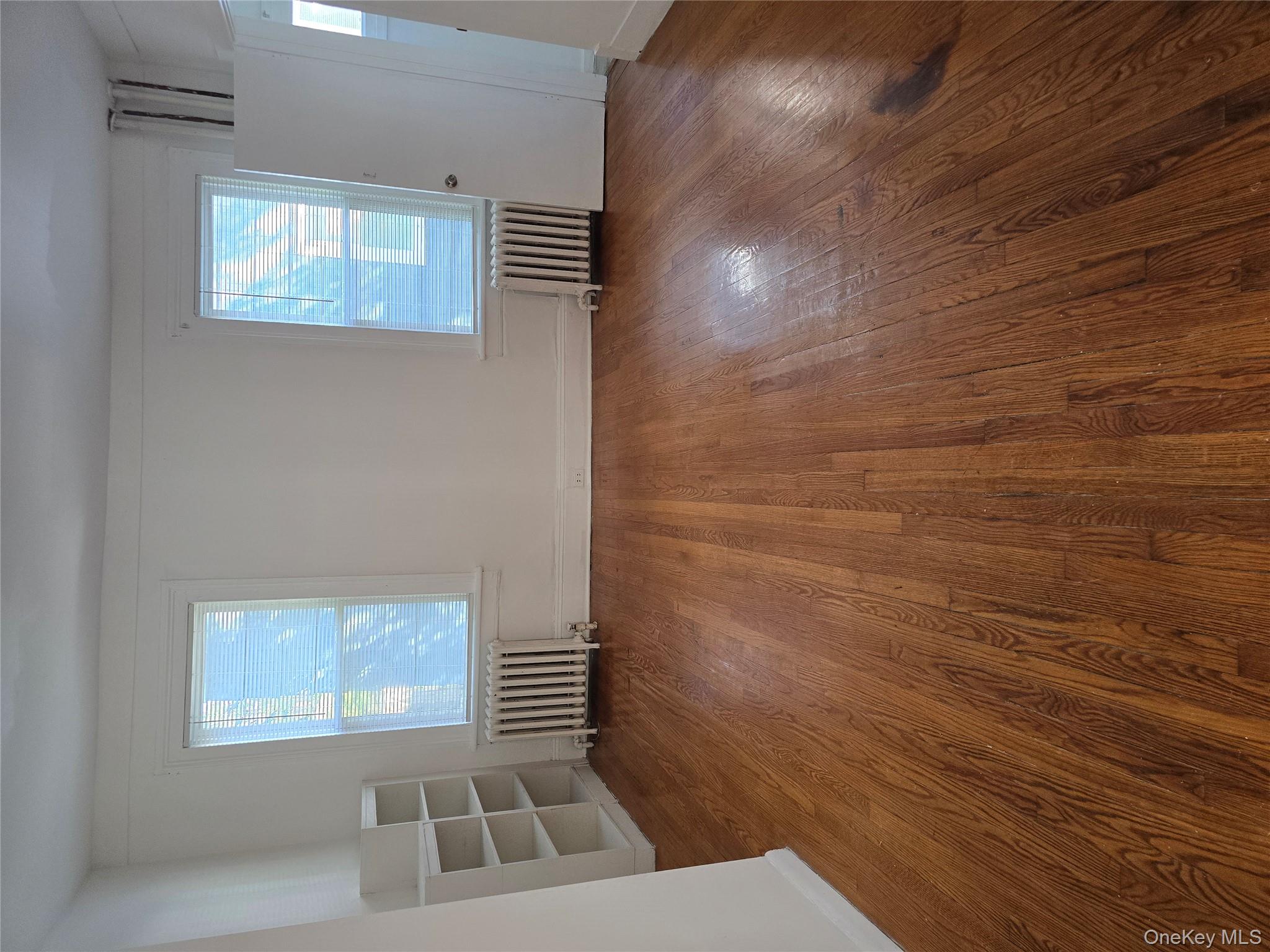 19 Elizabeth Street, Unit 1 Port Jervis, NY 12771 - Photo 8 of 16 an empty room with wooden floor and windows