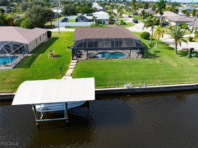 an aerial view of a house with swimming pool garden and outdoor seating