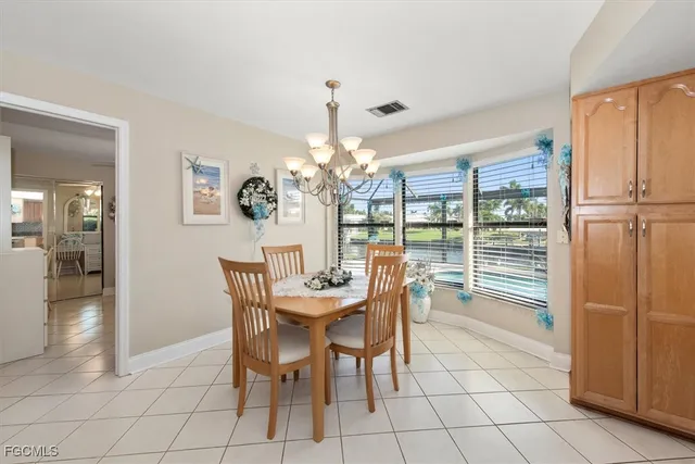 a view of a dining room with furniture and chandelier