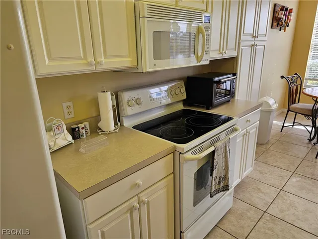 a view of a patio with table and chairs