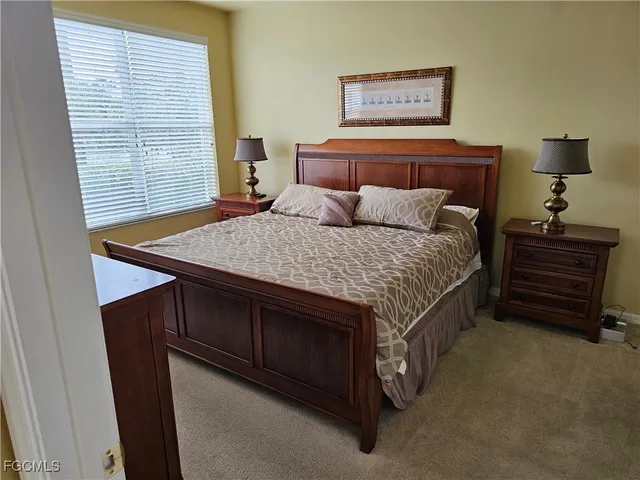 a bathroom with a granite countertop sink a mirror and shower