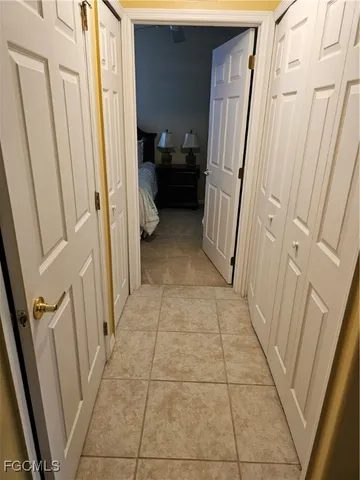 a bedroom with a bed and painting on the wall