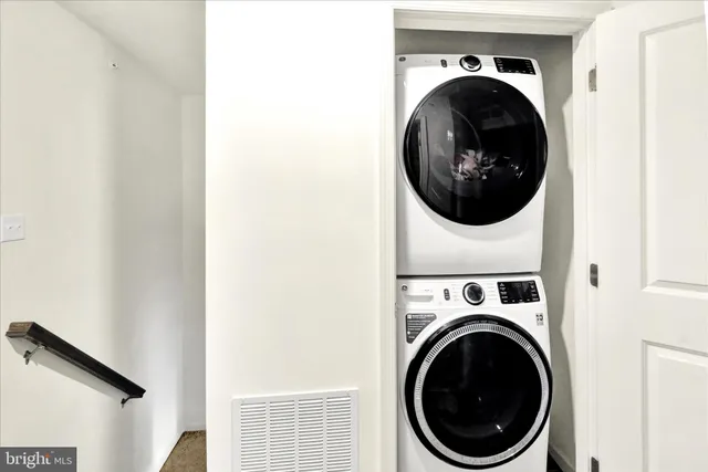 a view of a hallway with washer and dryer