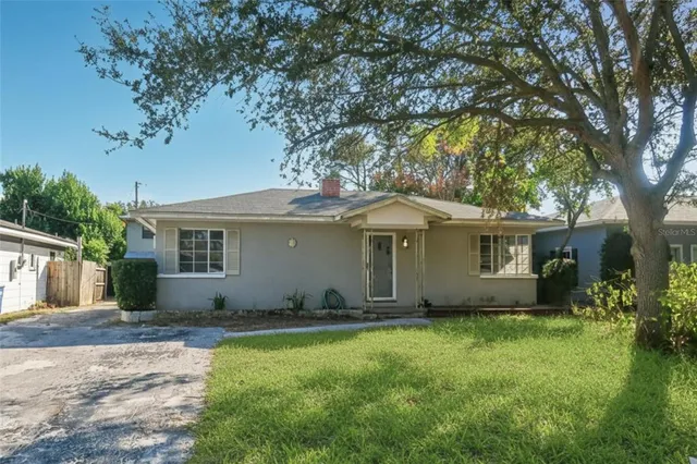 a front view of house with yard and trees