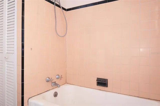 a bathroom with a bath tub and shower